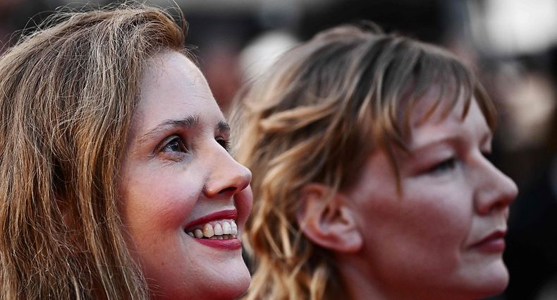 French film director Justine Triet (L) and German actress Sandra Hueller arrive for the Closing Ceremony and the screening of the film "Elemental" during the 76th edition of the Cannes Film Festival in Cannes, southern France, on May 27, 2023. (Photo by LOIC VENANCE / AFP)
