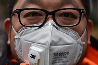 A man wearing a protective mask looks on while visiting the Jing'an temple in Shanghai on January 22, 2020. - A new virus that has killed nine people, infected hundreds and already reached the United States could mutate and spread, China warned January 22, as authorities scrambled to contain the disease during the Lunar New Year travel season. (Photo by HECTOR RETAMAL / AFP)