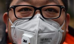 A man wearing a protective mask looks on while visiting the Jing'an temple in Shanghai on January 22, 2020. - A new virus that has killed nine people, infected hundreds and already reached the United States could mutate and spread, China warned January 22, as authorities scrambled to contain the disease during the Lunar New Year travel season. (Photo by HECTOR RETAMAL / AFP)