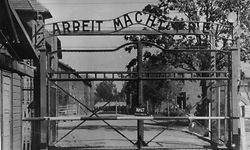 FILE - An undated image shows the main gate of the Nazi concentration camp Auschwitz in Poland.  Writing over the gate reads: "Arbeit macht frei" (Work Sets You Free). A 94-year-old man who was deported from the U.S. for lying about his Nazi past was ordered released from custody Friday Dec. 6, 2013 after a German court said it has "serious doubts" that he is fit to stand trial on charges he served as an Auschwitz death camp guard. The state court in Ellwangen,  said in a statement it had concluded that Hans Lipschis was suffering from the onset of dementia, based on two meetings with the suspect and a psychiatric assessment, and that he was easily disoriented.  (AP Photo/File)