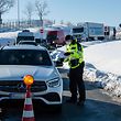 An officer of the Federal Police controls car drivers at the German-Czech border near Breitenau, eastern Germany, on February 14, 2021. - Germany implemented more measures to keep coronavirus variants at bay, banning travel from Czech border regions and Austria's Tyrol after a troubling surge in contagious mutations. (Photo by JENS SCHLUETER / AFP)