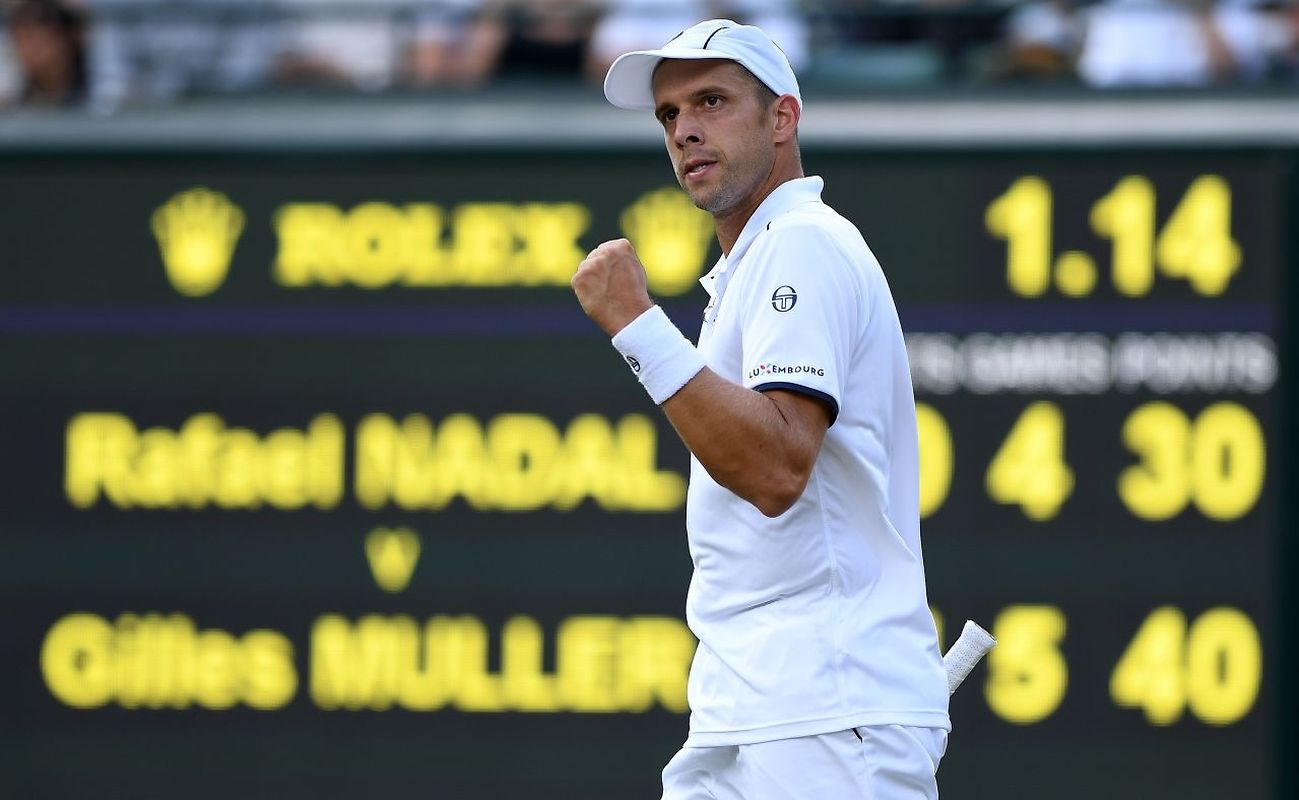 Luxembourg's Gilles Muller celebrates after winning the second set against Spain's Rafael Nadal during their men's singles fourth round match on the seventh day of the 2017 Wimbledon Championships 