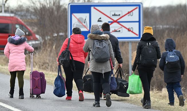 Ukrainian refugees cross the border on foot in Barabas, Hungary