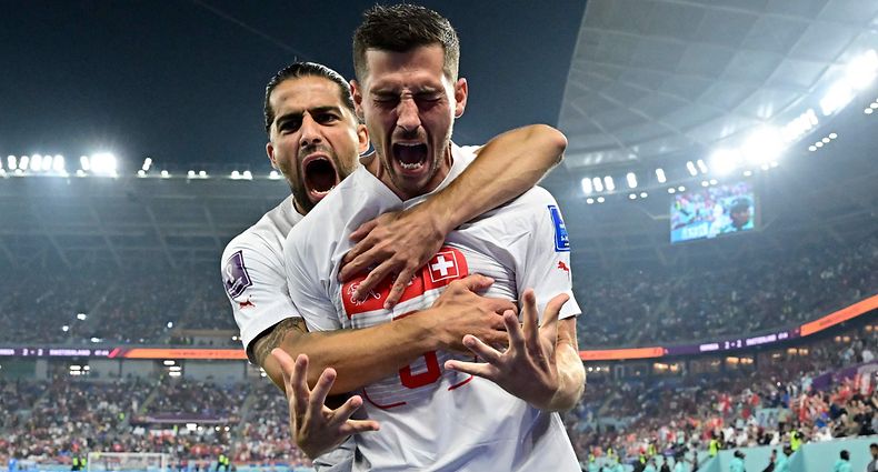 Switzerland's midfielder #08 Remo Freuler (R) celebrates with Switzerland's defender #13 Ricardo Rodriguez after scoring his team's third goal during the Qatar 2022 World Cup Group G football match between Serbia and Switzerland at Stadium 974 in Doha on December 2, 2022. (Photo by JAVIER SORIANO / AFP)