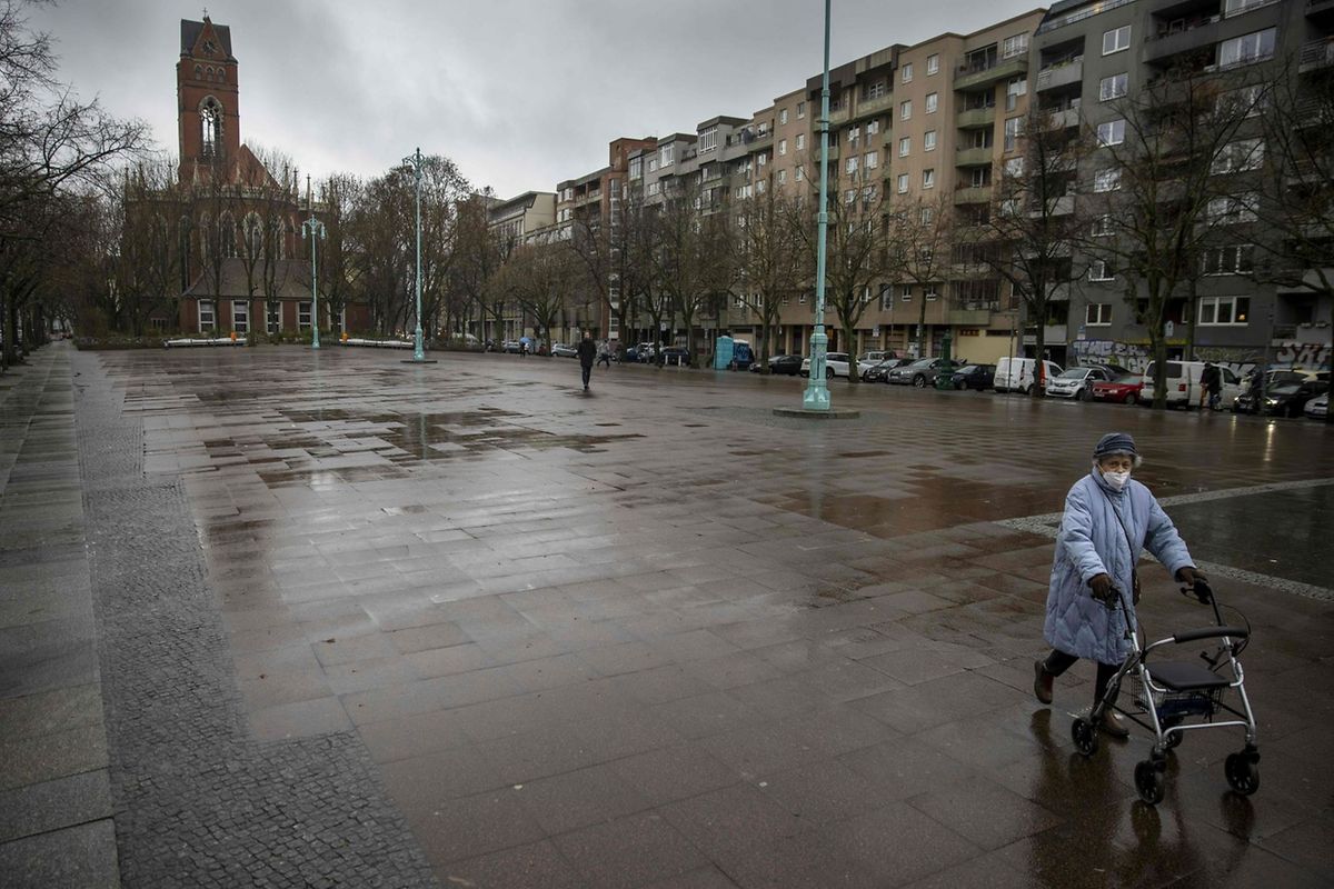 A woman makes her way across the largely deserted Winterfeldtplatz square, a tourist hot spot in Berlin's Schoeneberg district Photo: AFP