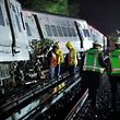 Emergency responders work near a train that sits derailed near the community of New Hyde Park on Long Island in New York, U.S, October 9, 2016.  REUTERS/Eduardo Munoz