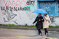 Graffiti in a loyalist area of south Belfast, Northern Ireland against an Irish sea border is seen on February 2, 2021. - The British government today condemned threats to port workers implementing post-Brexit trade checks in Northern Ireland and called for clear heads to ease tensions. (Photo by PAUL FAITH / AFP)