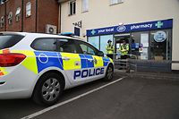 Police officers are seen standing guard outside a local pharmacy in Amesbury, nine miles north of Salisbury, southern England, on July 4, 2018 where two people were found unconcious at a residence in Amesbury in circumstances that caused a major incident to be declared were believed to have visited. 
Two people have been hospitalised in a critical condition for exposure to an "unknown substance" in the same British city where former Russian spy Sergei Skripal and his daughter were poisoned with a nerve agent earlier this year. British police declared a "major incident" after the couple, a man and a woman in their 40s, were discovered unconscious at a house in a quiet, newly-built area in Amesbury, with a number of locations cordoned off by police.
 / AFP PHOTO / Geoff CADDICK
