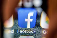 An illustration picture taken through a magnifying glass on March 28, 2018 in Moscow shows the icon for the social networking app Facebook on a smart phone screen.
Facebook said on March 28, 2018 it would overhaul its privacy settings tools to put users "more in control" of their information on the social media website. The updates include improving ease of access to Facebook's user settings, a privacy shortcuts menu and tools to search for, download and delete personal data stored by Facebook. / AFP PHOTO / Mladen ANTONOV