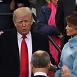 Donald Trump (L) is sworn in as the 45th US president by Supreme Court Chief Justice John Roberts in front of the Capitol in Washington on January 20, 2017.