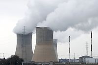 Members of the Belgian civil protection and a helicopter search for a missing 12-year-old boy after he was, according to local media, taken away by a flooded river, near the cooling towers of the Tihange nuclear plant of Electrabel, Belgium, January 24, 2016. REUTERS/Francois Lenoir