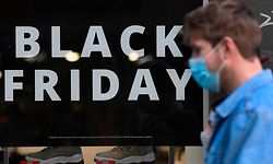 A sign announces a price markdown for Black Friday on the display window of a shop in Madrid on November 23, 2020. (Photo by GABRIEL BOUYS / AFP)