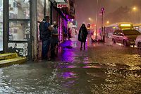 NEW YORK, NY - SEPTEMBER 01: People make their way in rainfall from the remnants of Hurricane Ida on September 1, 2021, in the Bronx borough of New York City. The once category 4 hurricane passed through New York City, dumping 3.15 inches of rain in the span of an hour at Central Park. David Dee Delgado/Getty Images/AFP == FOR NEWSPAPERS, INTERNET, TELCOS & TELEVISION USE ONLY ==
