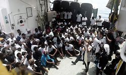 A handout picture taken on June 11, 2018 and released by the SOS Mediterranee NGO on June 12, 2018 shows members of the NGO talking to rescued migrants aboard the French NGO's ship Aquarius, in the search and rescue zone in the Mediterranean sea. 
Hundreds of migrants stranded on a rescue vessel in the Mediterranean will be taken to Spain with the help of two Italian ships, a charity said on June 12, 2018, after deteriorating weather conditions sparked fears for their safety. The 629 migrants, including pregnant women and scores of children, have been at the heart of a huge row between Malta and Italy since their maritime rescue by French charity SOS Mediterranee on June 9.
 / AFP PHOTO / SOS MEDITERRANEE / Karpov / RESTRICTED TO EDITORIAL USE - MANDATORY CREDIT "AFP PHOTO / KARPOV / SOS MEDITERRANEE" - NO MARKETING NO ADVERTISING CAMPAIGNS - DISTRIBUTED AS A SERVICE TO CLIENTS

