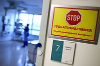A sign that reads 'Stop! Isolation room' is pictured in the intensive care unit of the community hospital in Magdeburg, eastern Germany, on April 16, 2020 during the novel coronavirus COVID-19 pandemic. (Photo by Ronny Hartmann / AFP)