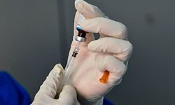 A member of the medical staff clad in protective gear prepares to give an infant the Bacillus Calmette�Gu�rin (BCG) vaccine for tuberculosis at a community health centre in Banda Aceh on June 15, 2020. - In the worldwide battle against COVID-19, it was reported in May that scientists were investigating whether a century-old tuberculosis vaccine might offer some additional protection against the novel coronavirus. But the World Health Organization, for its part, said in April that there is no evidence that BCG protects people against infection with COVID-19. (Photo by CHAIDEER MAHYUDDIN / AFP)