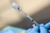 (FILES) In this file photo taken on August 07, 2021, a syringe is filled with a first dose of the Pfizer Covid-19 vaccine at a mobile vaccination clinic in Los Angeles. - People who received Johnson & Johnson's Covid-19 vaccine may benefit from a booster dose of Pfizer or Moderna, preliminary results of a US study published October 13, 2021 showed. (Photo by Patrick T. FALLON / AFP)