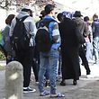 Refugees queue up at the yard of the Central Registration Office for Asylum Seekers (Zentrale Aufnahmestelle fuer Asylbewerber, or ZAA) of the State Office for Health and Social Services (Landesamt fuer Gesundheit und Soziales, or LAGeSo) in Berlin September 7, 2015. The numbers of migrants have spiked since September 4, 2015, when Austria and Germany threw open their borders and eased travel restrictions to allow in thousands who had made it to Hungary, which has balked at the influx.  AFP PHOTO / TOBIAS SCHWARZ