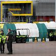 London Ambulance staff members work in the car park at the ExCeL London exhibition centre in London on March 30, 2020, which has been transformed into a field hospital to be known as the NHS Nightingale Hospital, to help with the novel coronavirus COVID-19 pandemic. - Life in locked-down Britain may not return to normal for six months or longer as it battles the coronavirus outbreak, a top health official warned on Sunday, as the death toll reached passed 1,200. (Photo by Tolga AKMEN / AFP)