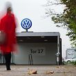 A woman arrives at gate 17 of the plant of German car maker Volkswagen (VW) in Wolfsburg, central Germany, on October 6, 2015. Several engineers at scandal-hit German automaker Volkswagen had admitted to installing the device in the company's cars aimed at cheating pollution tests. The global scam had wiped more than 40 percent off Volkswagen's market capitalisation and led chief executive Martin Winterkorn to resign.     AFP PHOTO / DPA / JULIAN STRATENSCHULTE   +++   GERMANY OUT   +++