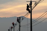 Workers repair electricity pylons and wires damaged during an earthquake in February, in a rural area near Santiago May 26, 2010. The 8.8-magnitude earthquake on February 27 was one of the world's most powerful in a century and killed more than 700 people. REUTERS/Ivan Alvarado (CHILE - Tags: DISASTER SOCIETY EMPLOYMENT BUSINESS IMAGES OF THE DAY)