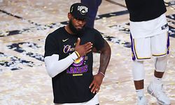 (FILES) In this file photo taken LeBron James #23 of the Los Angeles Lakers reacts after winning the 2020 NBA Championship over the Miami Heat in Game Six of the 2020 NBA Finals at AdventHealth Arena at the ESPN Wide World Of Sports Complex on October 11, 2020 in Lake Buena Vista, Florida. - American sport stars celebrated Joe Biden's victory on November 7, 2020, saying the election of the 46th president of the US has restored their faith in democracy after four tumultuous years under Donald Trump. Athletes such as LeBron James, Magic Johnson and Megan Rapinoe took to social media to share their feelings after the US media monitoring the electoral vote count in key states like Pennsylvania declared Biden the winner. (Photo by Mike Ehrmann / GETTY IMAGES NORTH AMERICA / AFP)