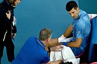 Serbia's Novak Djokovic takes a medical time out as he competes against Bulgaria's Grigor Dimitrov during their men's singles match on day six of the Australian Open tennis tournament in Melbourne on January 21, 2023. (Photo by ANTHONY WALLACE / AFP) / -- IMAGE RESTRICTED TO EDITORIAL USE - STRICTLY NO COMMERCIAL USE --