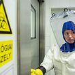 A scientist wearing her Personal protective equipment (PPE) enters the lab at the Szentgothai Research Center of Pecs University, in Pecs, Hungary on May 13, 2020 during their diagnostic activity to locate the nature of the virus strain and the connection to novel coronavirus COVID-19. (Photo by KAROLY ARVAI / POOL / AFP)