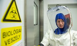 A scientist wearing her Personal protective equipment (PPE) enters the lab at the Szentgothai Research Center of Pecs University, in Pecs, Hungary on May 13, 2020 during their diagnostic activity to locate the nature of the virus strain and the connection to novel coronavirus COVID-19. (Photo by KAROLY ARVAI / POOL / AFP)