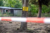 EDITORS NOTE: Graphic content / A picture taken on July 29, 2020 shows a sign on a tree reading "No entry to the property. Parents are liable for their children" after the police finished a two-day search in a garden allotment in the northern German city of Hanover on July 29, 2020, in connection with the disappearance of British girl Madeleine McCann. - Police revealed in June 2020 that they were investigating a 43-year-old German man over the 2007 disappearance of three-year-old "Maddie", saying they believe he killed her. Madeleine went missing from her family's holiday apartment in the Portuguese holiday resort of Praia da Luz on May 3, 2007, a few days before her fourth birthday, as her parents dined with friends at a nearby tapas bar. (Photo by Hauke-Christian Dittrich / AFP)