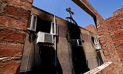 A picture shows the damage at the Abu Sifin church located in the densely populated Imbaba neighbourhood west of the Nile river, part of Giza governorate, on August 14, 2022, after more than 40 people were killed when a fire ripped through a Coptic Christian church during Sunday mass. - Witnesses described how people rushed into the burning house of worship to rescue those trapped but were soon overwhelmed by the heat and the deadly smoke. (Photo by Khaled DESOUKI / AFP)