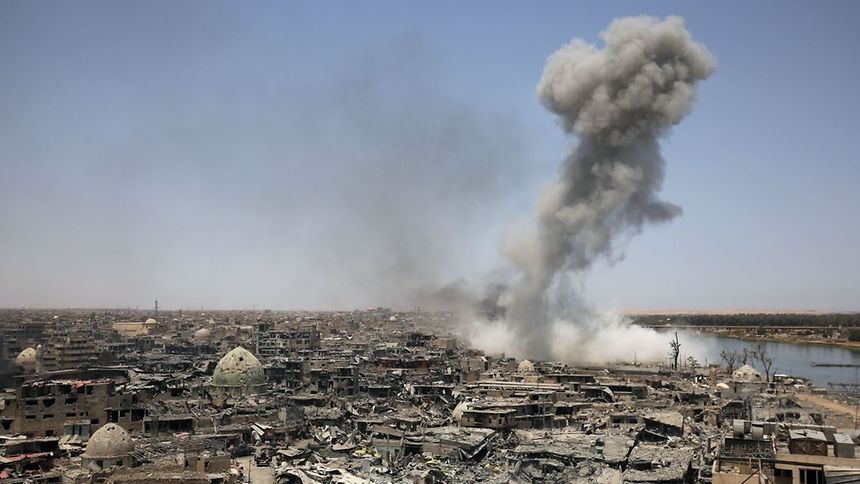 A picture taken on July 9, 2017, shows smoke billowing following an airstrike by US-led international coalition forces targeting Islamic State (IS) group in Mosul.