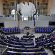German Chancellor Angela Merkel (C) speaks during a session of the Bundestag (lower house of parliament) on April 16, 2021 in Berlin. (Photo by Tobias SCHWARZ / AFP)