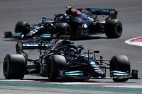 Mercedes' British driver Lewis Hamilton and Mercedes' Finnish driver Valtteri Bottas (back) compete during the Portuguese Formula One Grand Prix race at the Algarve International Circuit in Portimao on May 2, 2021. (Photo by GABRIEL BOUYS / AFP)