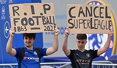Supporters hold up placards critical of the idea of a New European Super League, outside English Premier League club Chelsea's Stamford Bridge stadium in London on April 20, 2021, ahead of their game against Brighton. - The 14 Premier League clubs not involved in the proposed European Super League "unanimously and vigorously rejected" the plans at an emergency meeting on Tuesday. Liverpool, Arsenal, Chelsea, Manchester City, Manchester United and Tottenham Hotspur are the English clubs involved. (Photo by JUSTIN TALLIS / AFP)