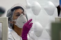 An employee works in the production of N95 face masks at a factory that produces 40,000 N95 masks per day, in Mexico City on May 21, 2020. - The company operates with the support of the city government and the National Autonomous University of Mexico (UNAM) and it will deliver 250,000 masks to the city hospitals. (Photo by ALFREDO ESTRELLA / AFP)