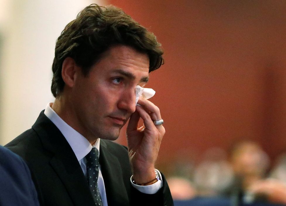 Canada's Prime Minister Justin Trudeau wipes a tear during funeral services for three of the victims of the deadly shooting at the Quebec Islamic Cultural Centre