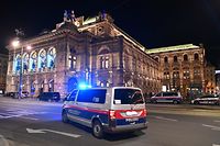 TOPSHOT - A police car drives in front of the opera house in the center of Vienna on November 2, 2020, following a shooting. - Two people, including one attacker, have been killed in a shooting in central Vienna, police said late November 2, 2020. Vienna police said in a Twitter post there had been "six different shooting locations" with "one deceased person" and "several injured", as well as "one suspect shot and killed by police officers". (Photo by JOE KLAMAR / AFP)