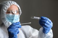 A medical worker preparing a PCR test