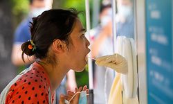A woman undergoes a swab sample test for the Covid-19 coronavirus at a swab collection site in Shanghai's Pudong district on May 31, 2022. (Photo by LIU JIN / AFP) / China OUT