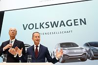 (ALTERNATIVE CROP) This photo taken on April 13, 2018 shows then newly appointed CEO of German car maker Volkswagen (VW) Herbert Diess (R) and VW supervisory board chairman Hans Dieter Poetsch giving a press conference at the company's headquarters in Wolfsburg, central Germany. - Volkswagen announced on May 19, 2020 to end one of the most potentially damaging cases in its "Dieselgate" scandal, paying 9 million euros in an out-of-court settlement to prevent its two bosses going to trial over market manipulation charges. The German car giant's chief executive Herbert Diess and supervisory board chief Hans Dieter Poetsch were in September 2019 charged for allegedly failing to inform shareholders in a timely manner about the pollution cheating scandal in 2015. (Photo by Odd ANDERSEN / AFP) / ALTERNATIVE CROP