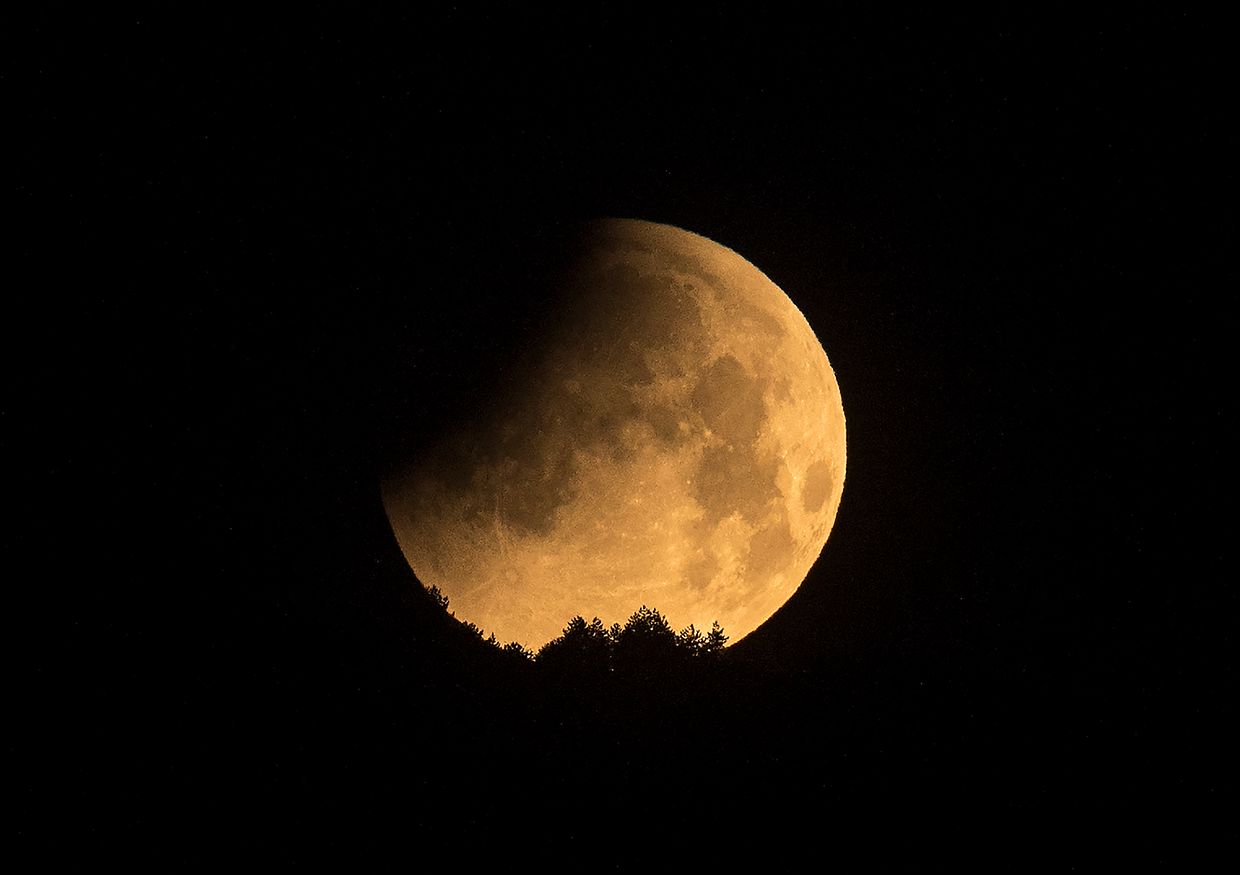 The moon is seen during a penumbral lunar eclipse in Skopje, on May 16, 2022. (Photo by Robert ATANASOVSKI / AFP)
