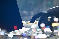 Artificial intelligence , chatbot , cyber communication , robot world and robo advisor. Robot finger point to laptop button with bokeh background.