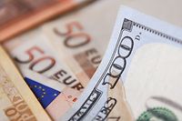 A $100-dollar bill is seen on top of Euro bills. The euro struck parity with the dollar for the first time in nearly 20 years on Tuesday as a cut in Russian gas supplies to Europe heightened fears of a recession in the eurozone.