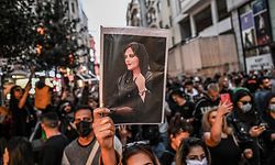 -- AFP PICTURES OF THE YEAR 2022 -- A protester holds a portrait of Mahsa Amini during a demonstration in support of Amini, a young Iranian woman who died after being arrested in Tehran by the Islamic Republic's morality police, on Istiklal avenue in Istanbul on September 20, 2022. - Amini, 22, was on a visit with her family to the Iranian capital when she was detained on September 13 by the police unit responsible for enforcing Iran's strict dress code for women, including the wearing of the headscarf in public. She was declared dead on September 16 by state television after having spent three days in a coma. (Photo by Ozan KOSE / AFP) / AFP PICTURES OF THE YEAR 2022