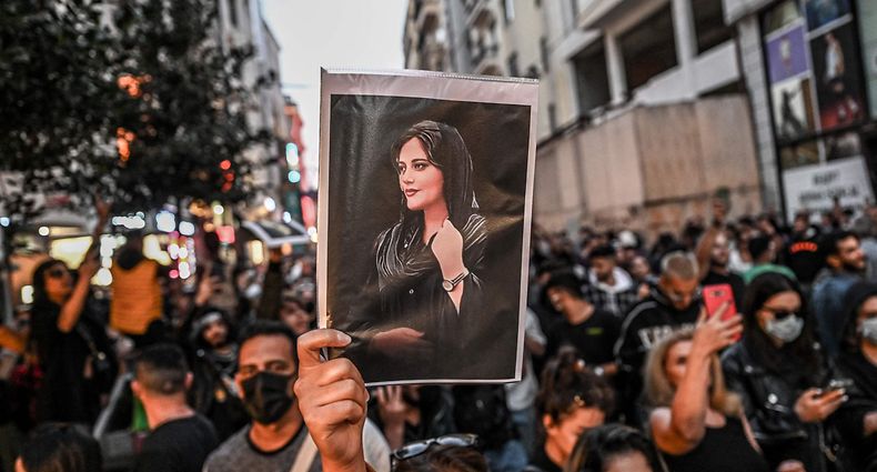 -- AFP PICTURES OF THE YEAR 2022 -- A protester holds a portrait of Mahsa Amini during a demonstration in support of Amini, a young Iranian woman who died after being arrested in Tehran by the Islamic Republic's morality police, on Istiklal avenue in Istanbul on September 20, 2022. - Amini, 22, was on a visit with her family to the Iranian capital when she was detained on September 13 by the police unit responsible for enforcing Iran's strict dress code for women, including the wearing of the headscarf in public. She was declared dead on September 16 by state television after having spent three days in a coma. (Photo by Ozan KOSE / AFP) / AFP PICTURES OF THE YEAR 2022