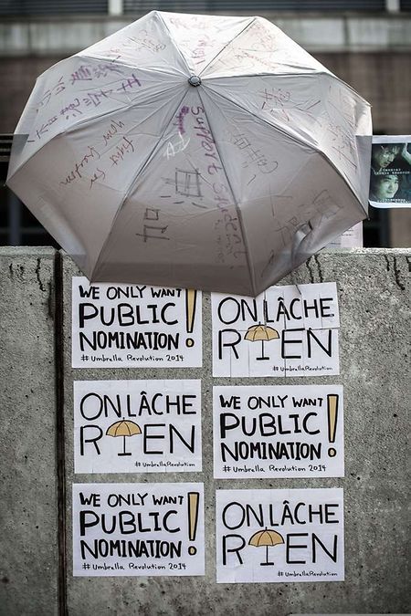 Support messages in French and English are seen displayed under an umbrella a gathering point of pro-democracy demonstrators in Hong Kong on October 2, 2014. Hong Kong has been plunged into the worst political crisis since its 1997 handover as pro-democracy activists take over the streets following China's refusal to grant citizens full universal suffrage. AFP PHOTO / Philippe Lopez