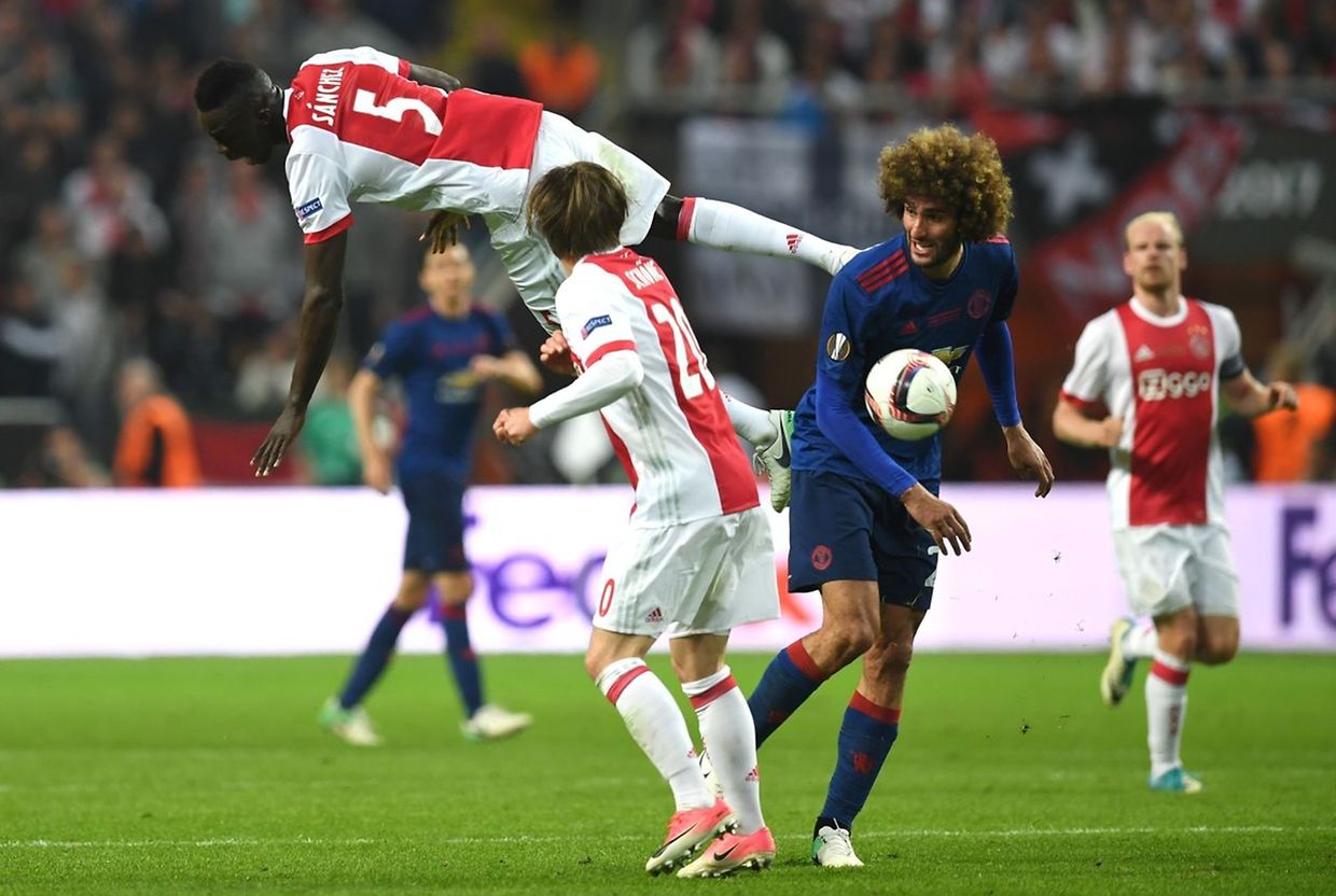 Ajax Colombian defender Davinson S�nchez jumps over Ajax Danish Midfielder Lasse Schone (20) and Manchester United's Belgian midfielder Marouane Fellaini (R) during the UEFA Europa League final football match Ajax Amsterdam v Manchester United on May 24, 2017 at the Friends Arena in Solna outside Stockholm. / AFP PHOTO / Paul ELLIS