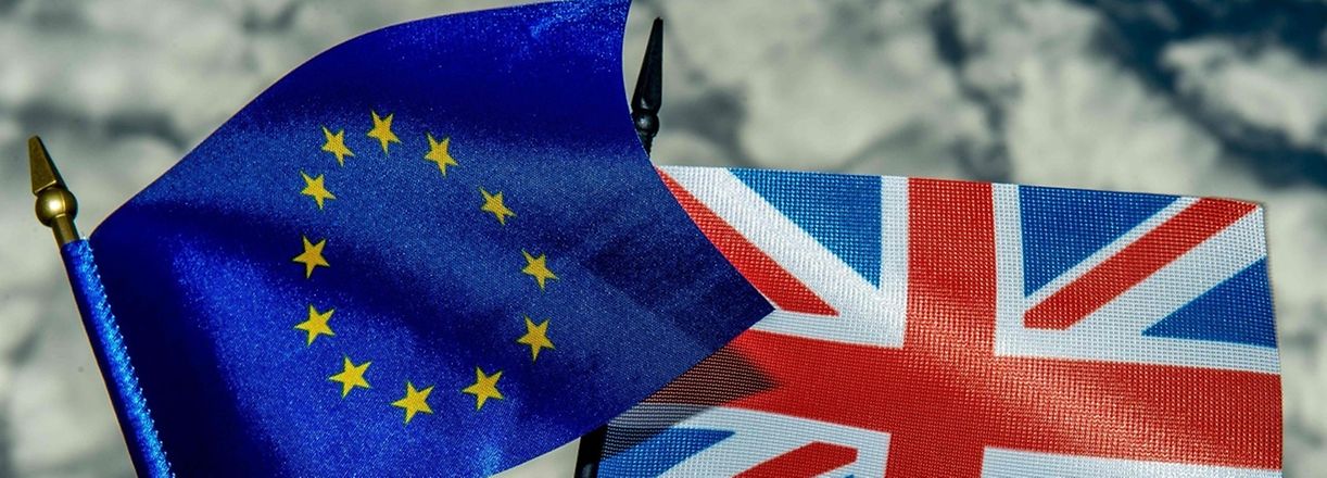 This photo illustration created on May 20, 2016 in Lille shows the flags of the European Union and the United Kingdom. 
On June 23, 2016 Great Britain will hold a referendum on whether or not the United Kingdom will remain within the European Union, often referred to as "Brexit." Group of Seven finance ministers on May 21 warned of the risks from a "shock" to the world economy if Britain votes to leave the European Union next month. / AFP PHOTO / PHILIPPE HUGUEN