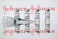 (FILES) This file photo taken on November 17, 2020 in London shows vials with Covid-19 Vaccine stickers attached and syringes with the logo of US pharmaceutical company Johnson & Johnson. - The European Medicines Agency said on March 9, 2021 that it is set to decide whether to authorise Johnson & Johnson's Janssen single-shot coronavirus vaccine for the EU on March 11. If approved by the Amsterdam-based regulator, the vaccine would be the fourth to get the green light for the 27-nation bloc, in a boost for its slow-starting vaccination programme. (Photo by JUSTIN TALLIS / AFP)